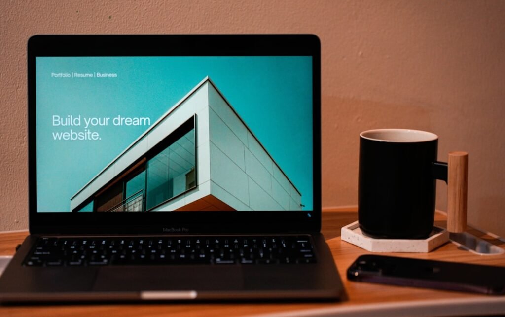 Website landing page design being reviewed on a laptop